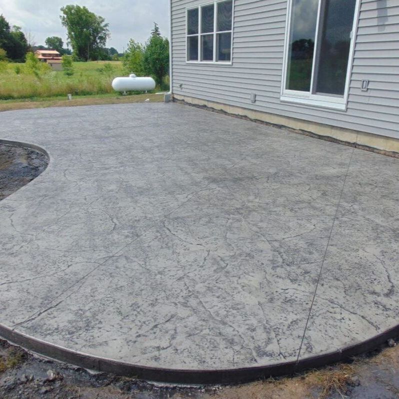 A gray stamped concrete patio