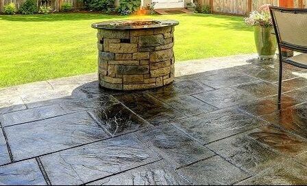 A back patio that has a stamped concrete effect with a shiny coating 