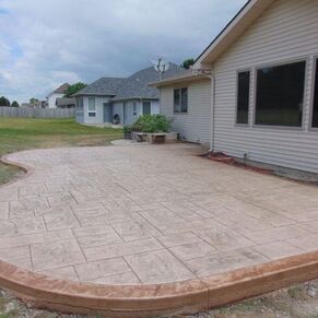 A brown stamped concrete patio